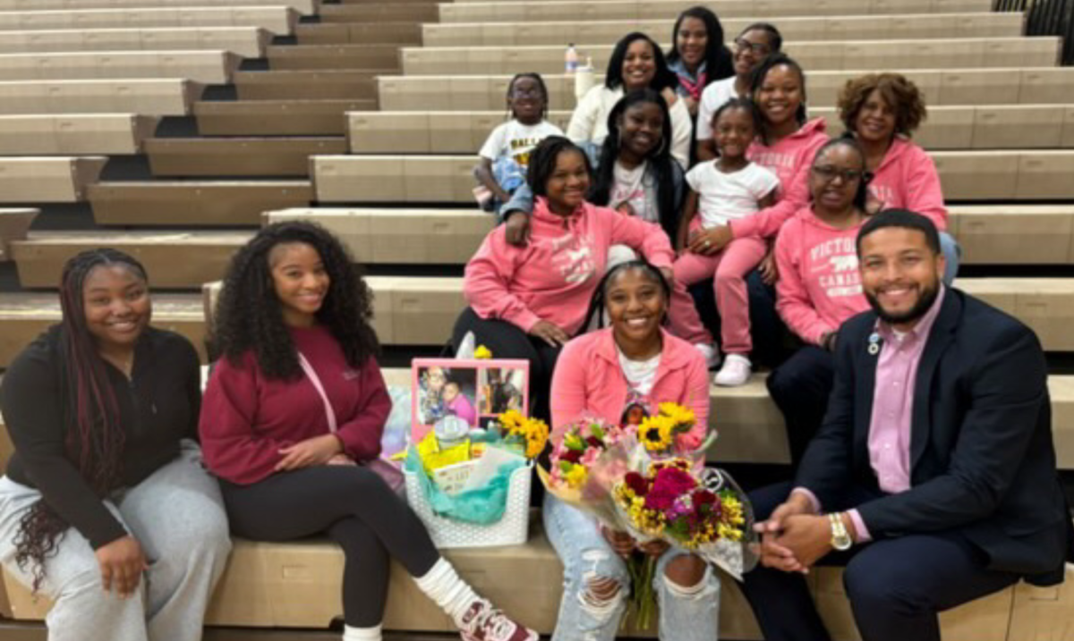 Jayohna Sims, 12, sits with her family on October 15th, 2024, in the North High MPC. Sims celebrated senior night for the athletic training program.

  